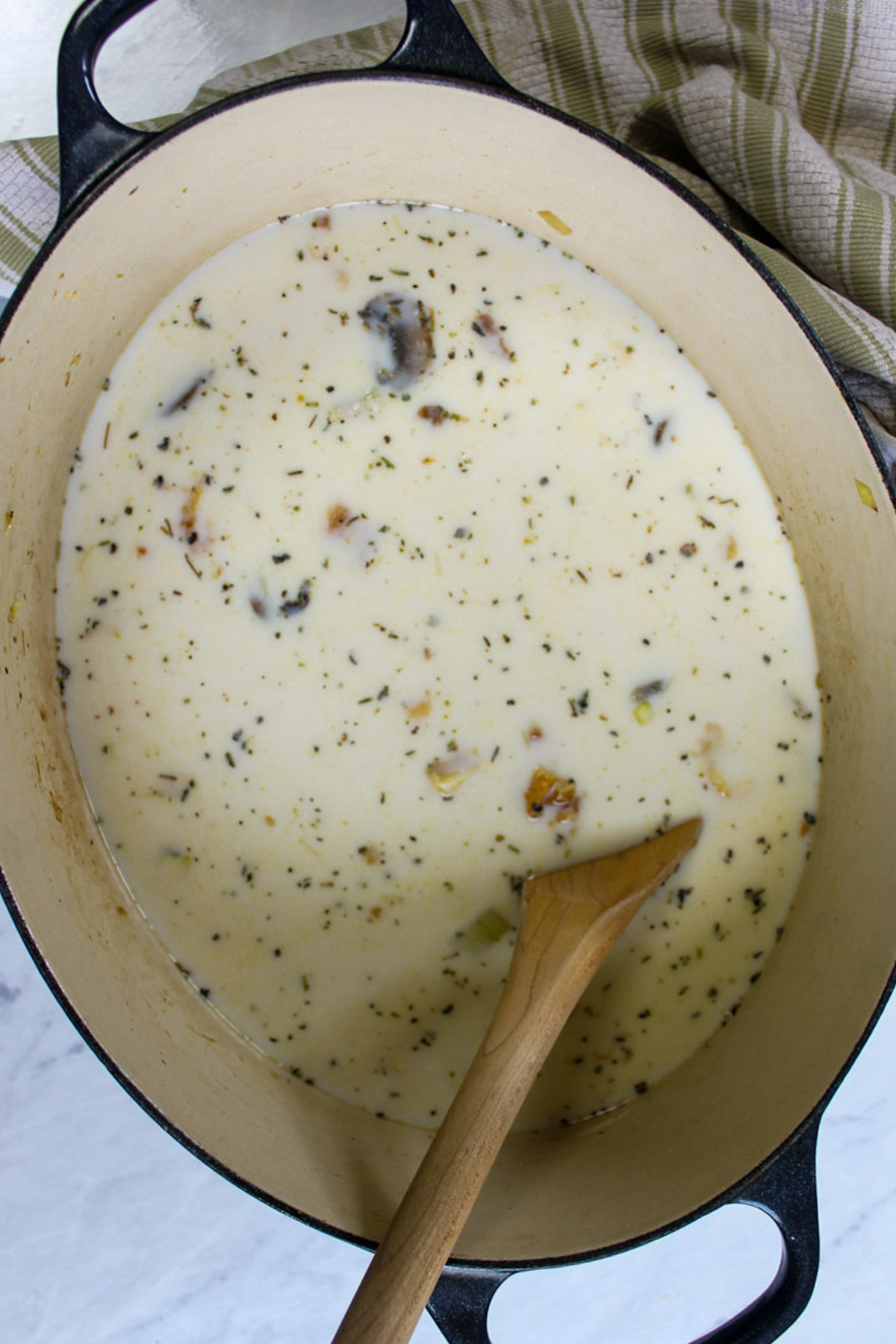 Milk, cream and chicken stock added to chicken wild rice soup.  