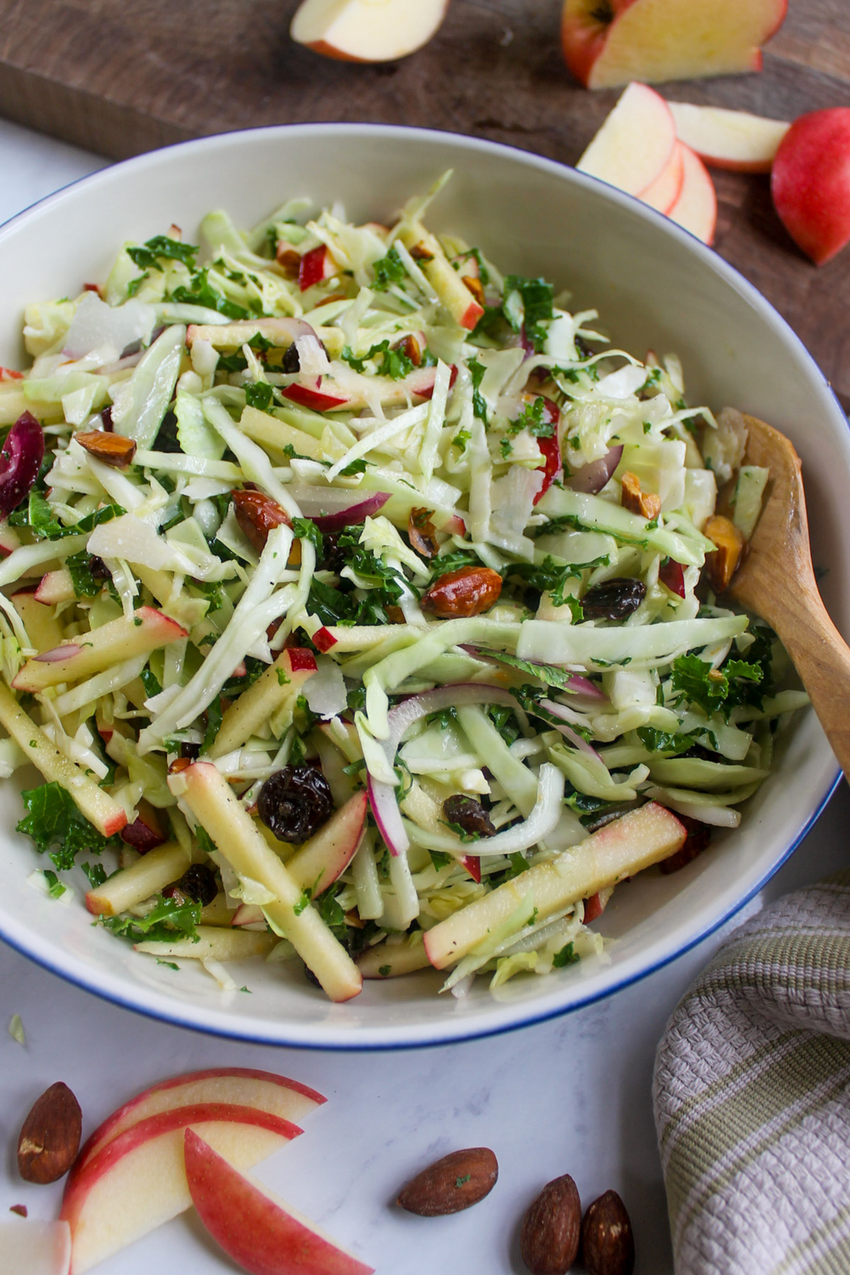 A bowl of kale apple slaw salad with honey apple cider vinaigrette.