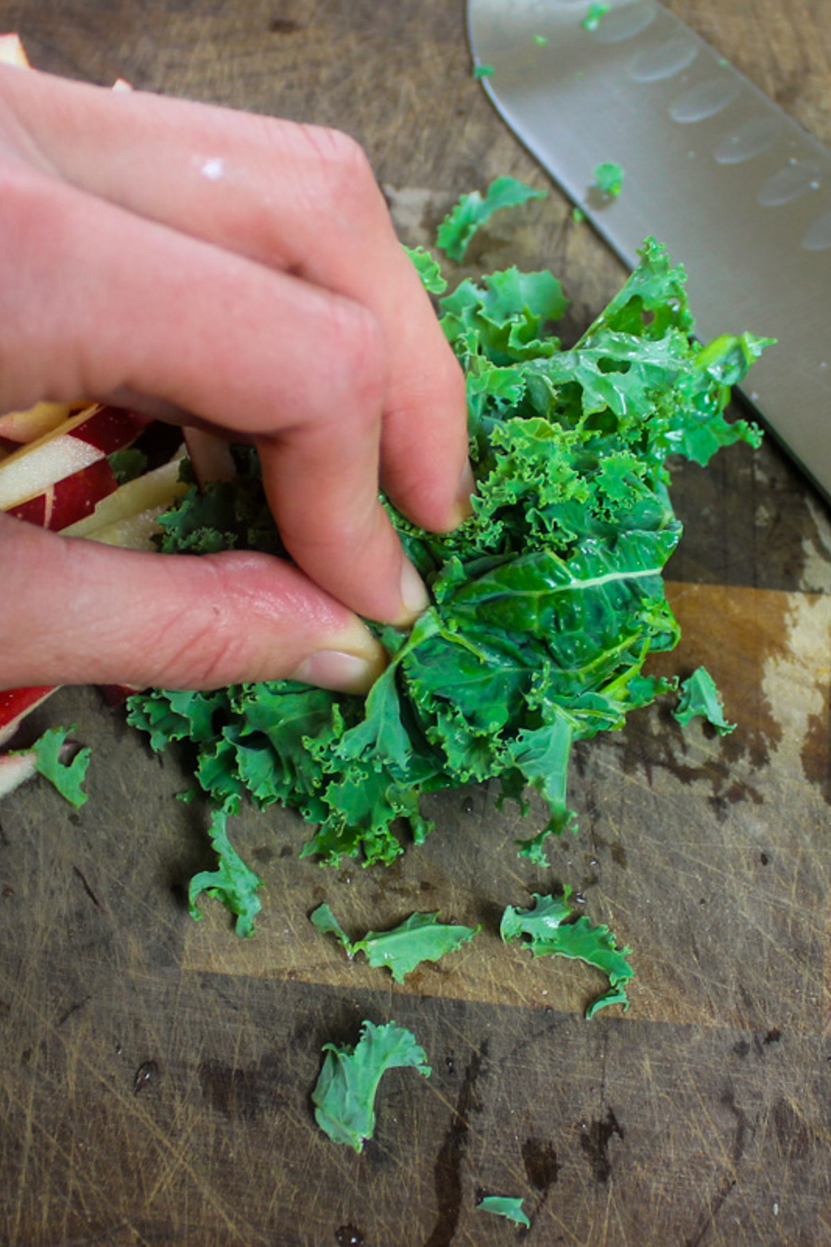 Thinly slicing kale leaves for kale apple slaw.