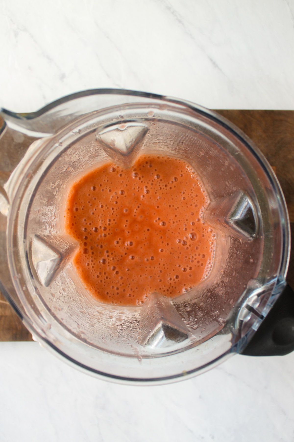 Strawberry rhubarb sauce pureed in a blender.