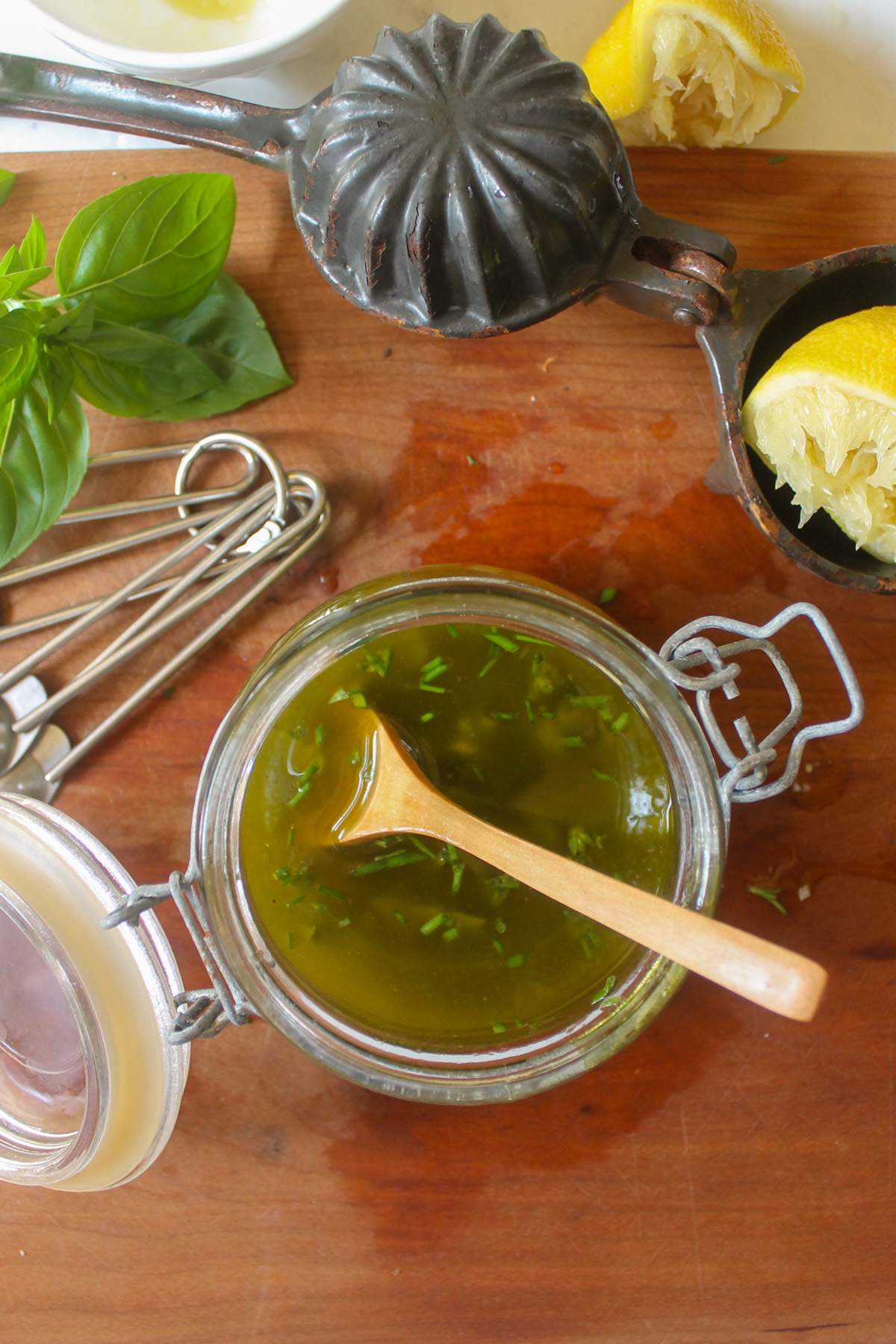 Making a jar or salad dressing with olive oil and herbs.