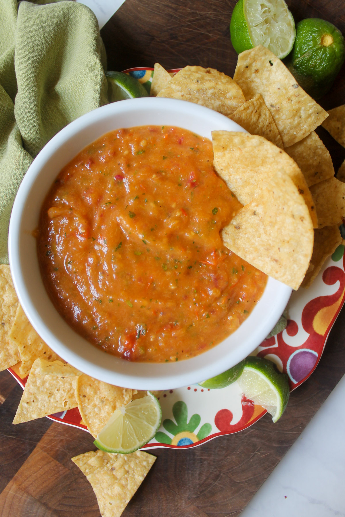 A bowl of Roasted Tomato Peach Salsa with tortilla chips.