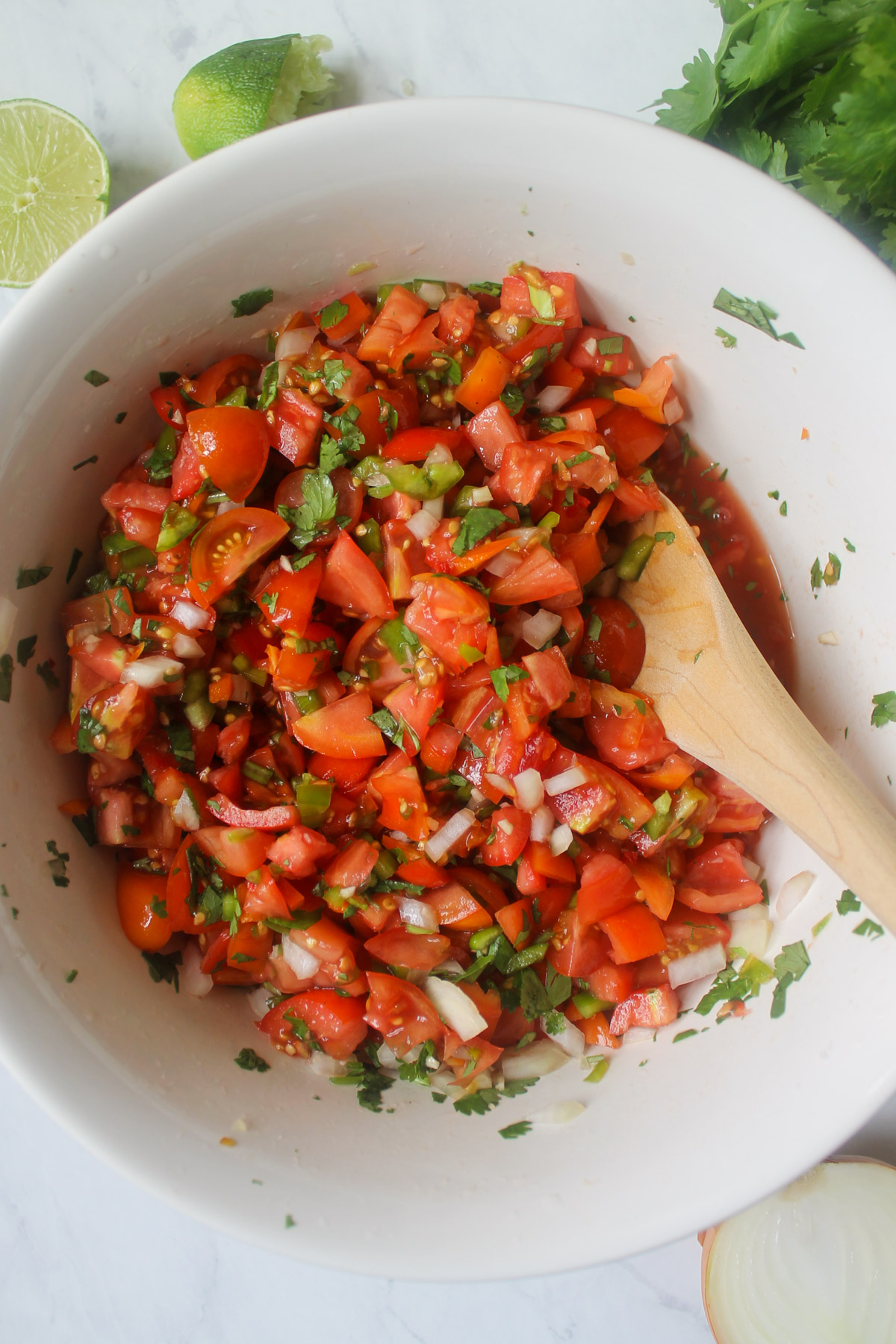 A mixing bowl of fresh chopped tomato salsa.