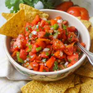 Fresh tomato salsa in a bowl with chips.