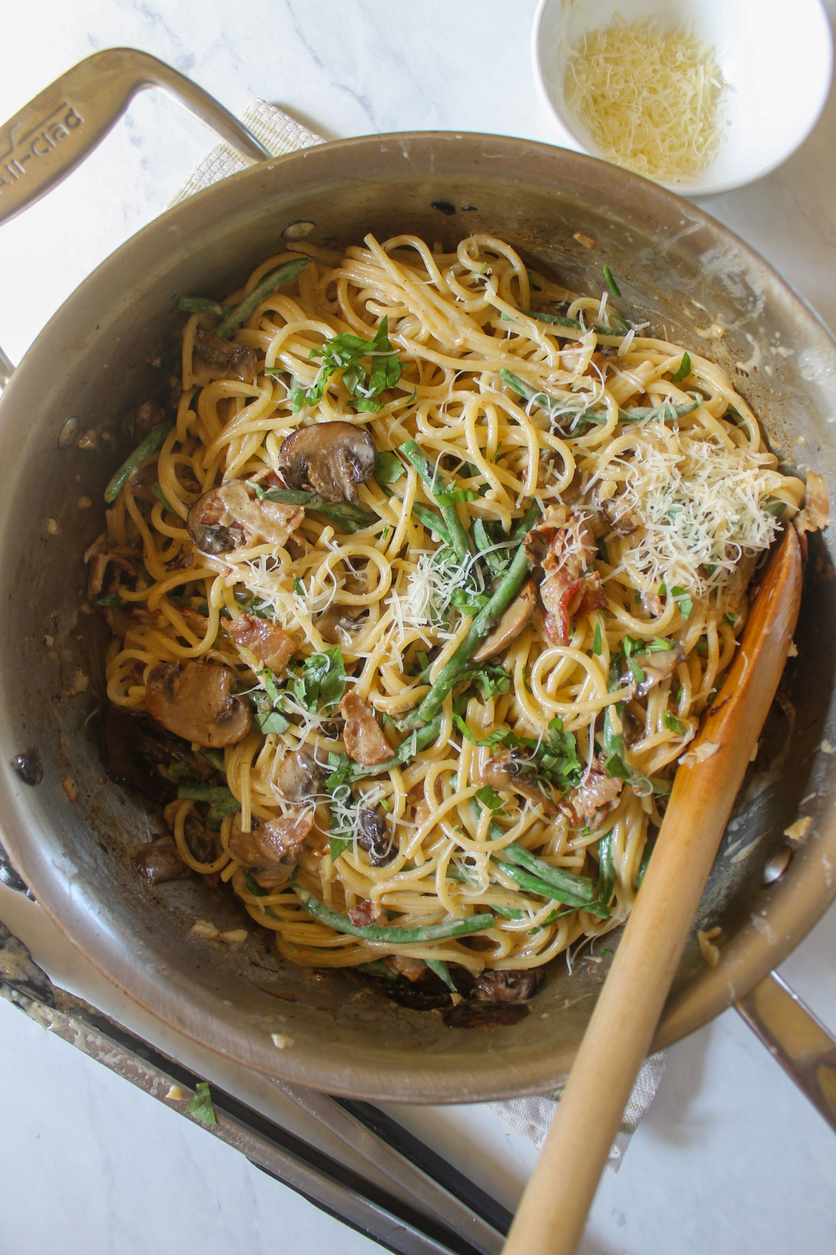 Green bean bacon spaghetti in a skillet.