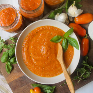 A bowl of pizza sauce from fresh garden tomatoes with basil.