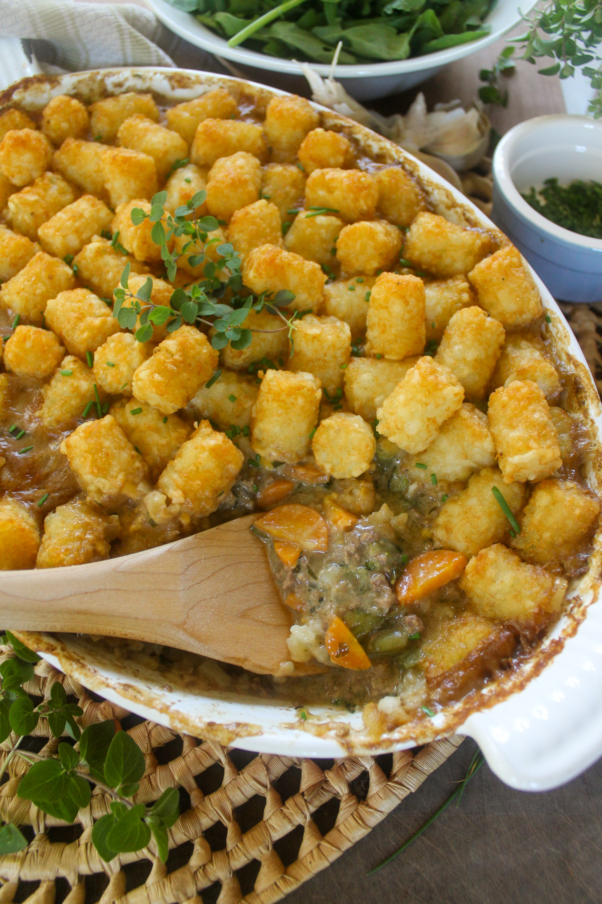 Baked tater tot casserole with fresh herbs and a salad.