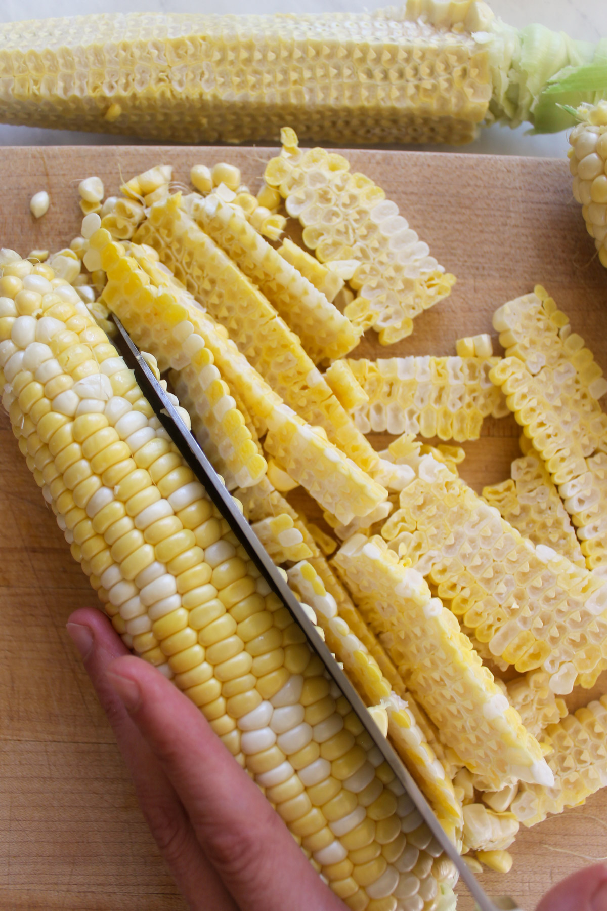 Slicing corn off the cob.