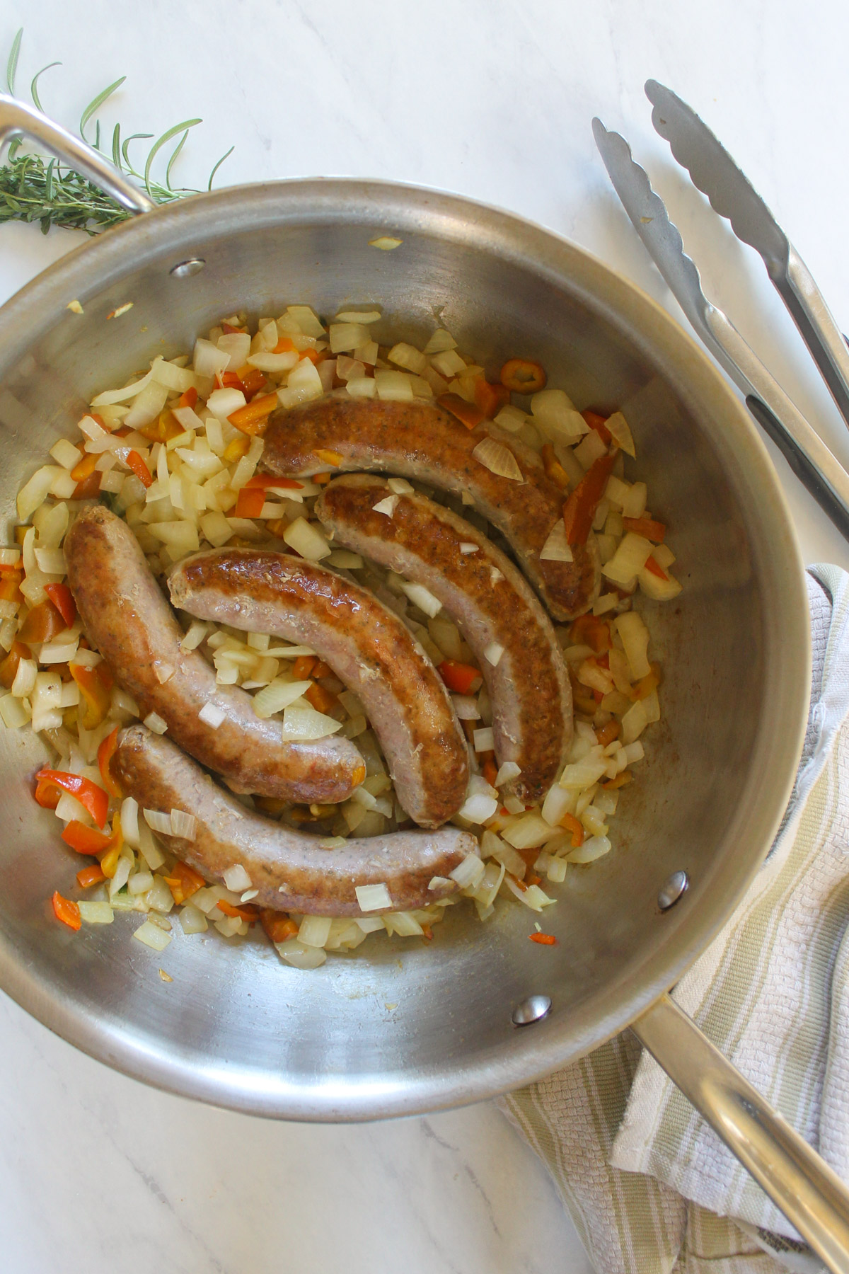 Seared sausage links with sautéd onions and peppers.