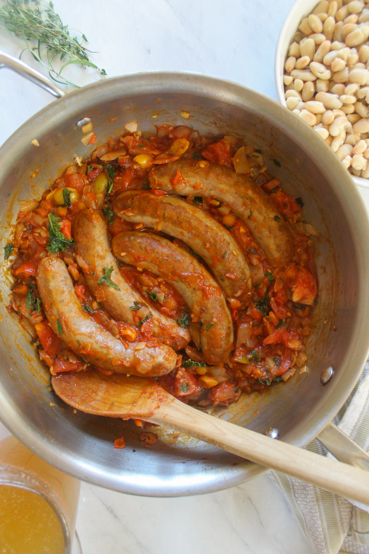 Cooked Italian sausage links in red tomato vegetable sauce.