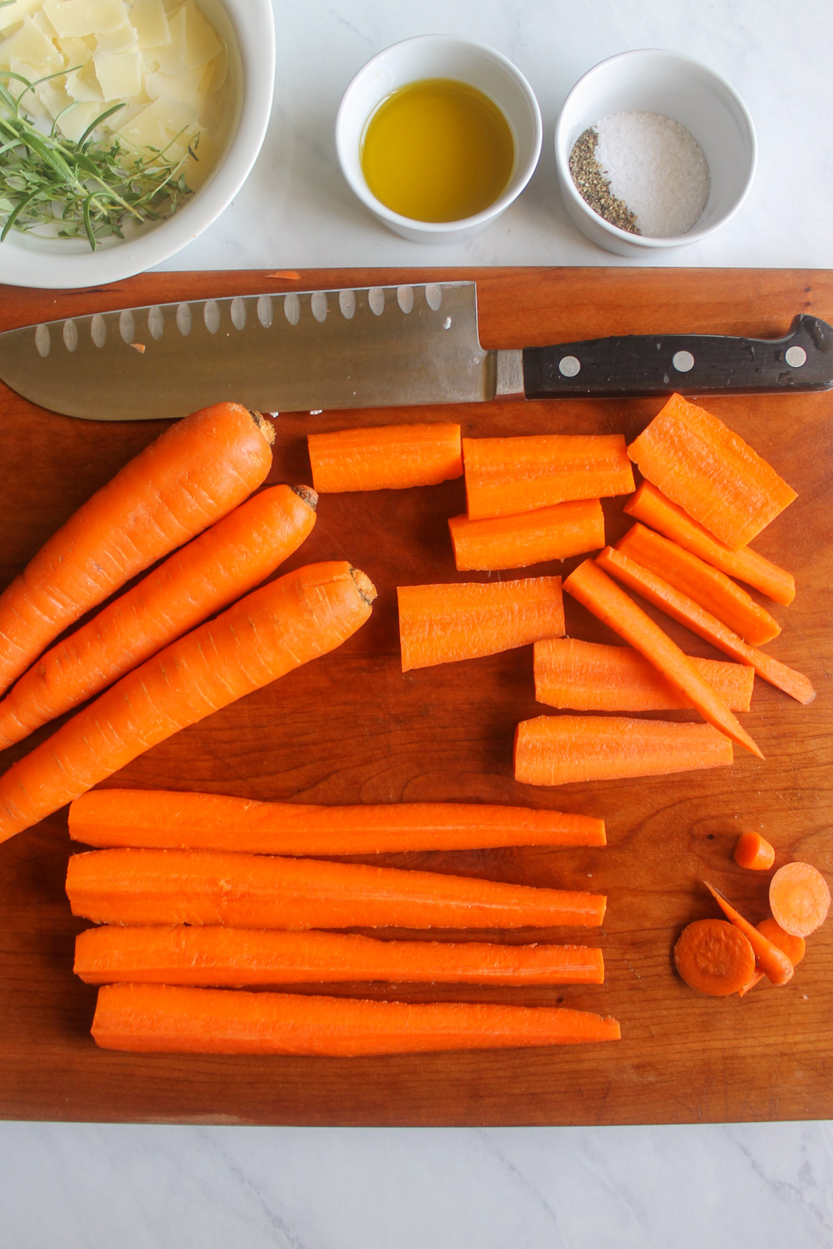 Slicing carrots on a cutting board.