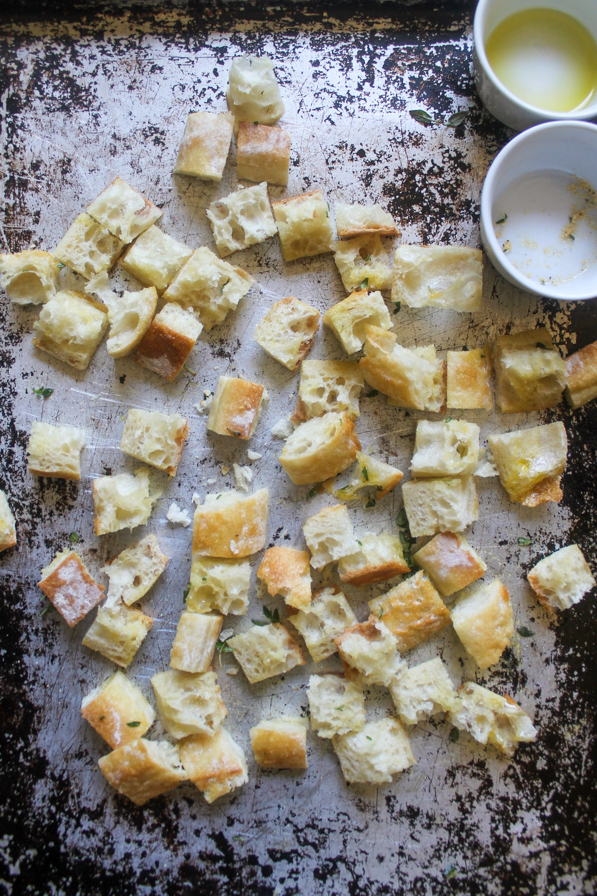 Cubed baguette on a sheet pan ready to make croutons.