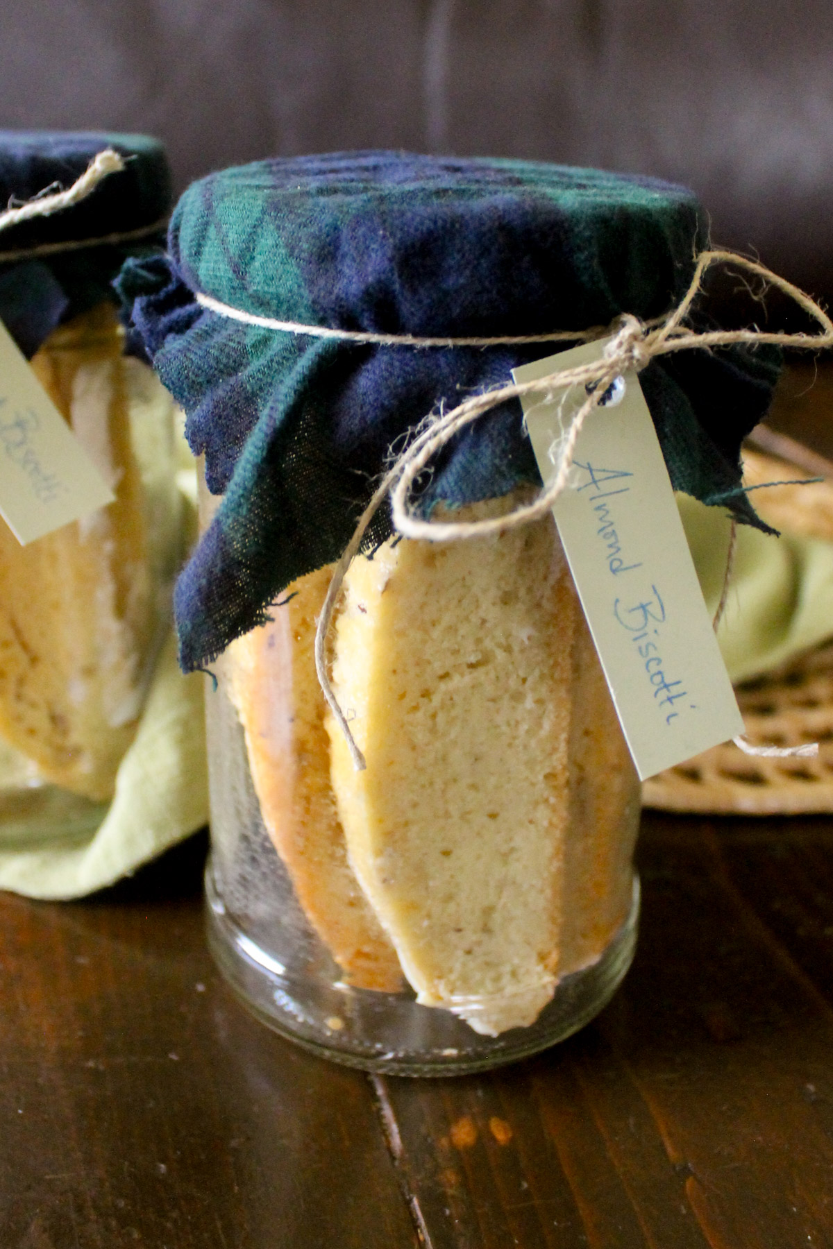 A gift of homemade Almond Biscotti in a jar tied with a tag.