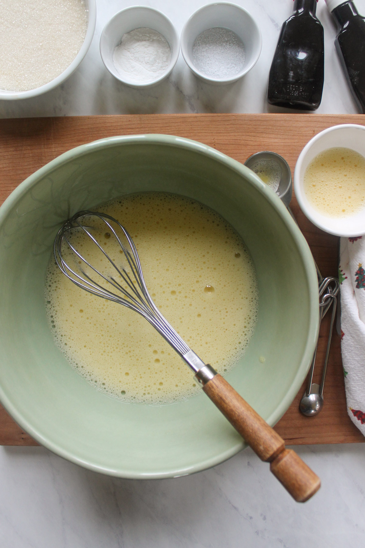 A green bowl with whisked eggs.