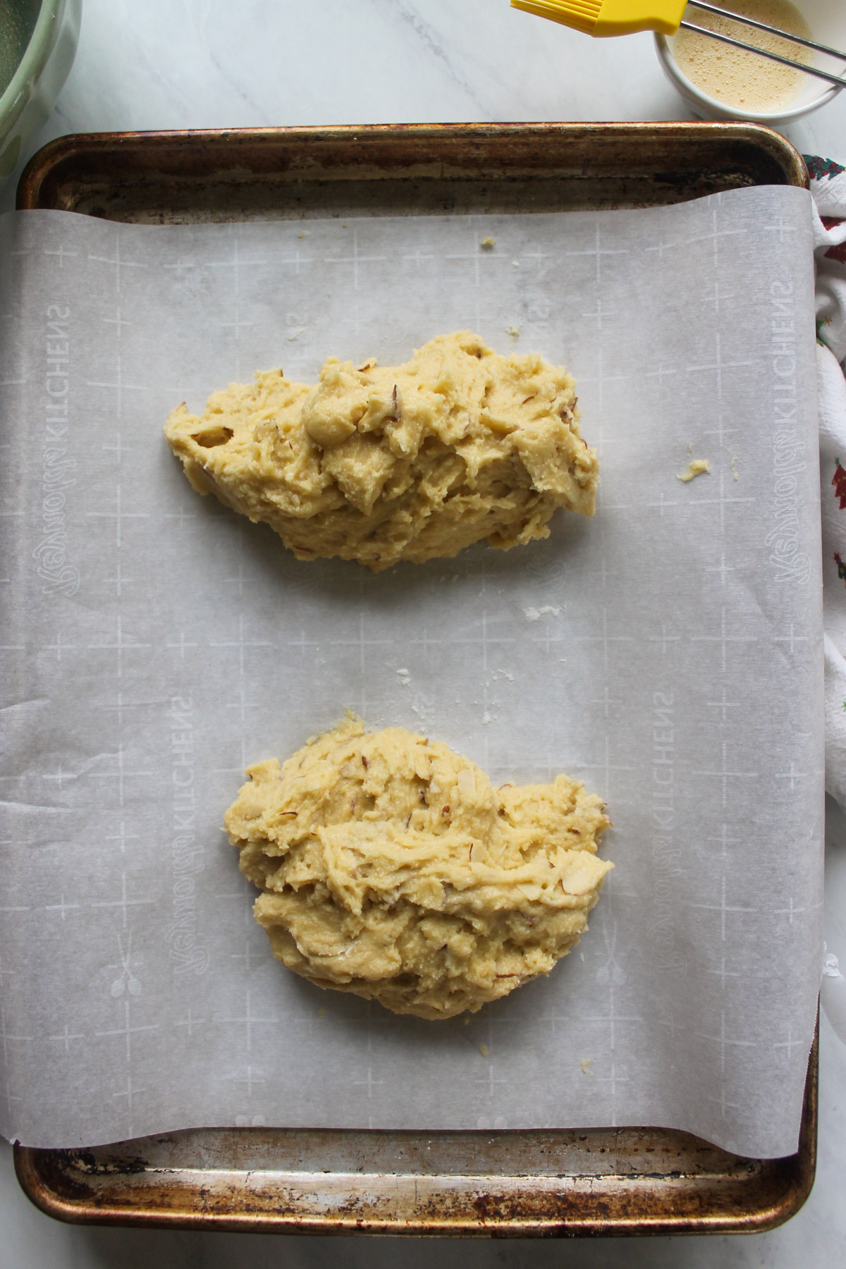 Batter divided on a sheet pan with parchment paper.