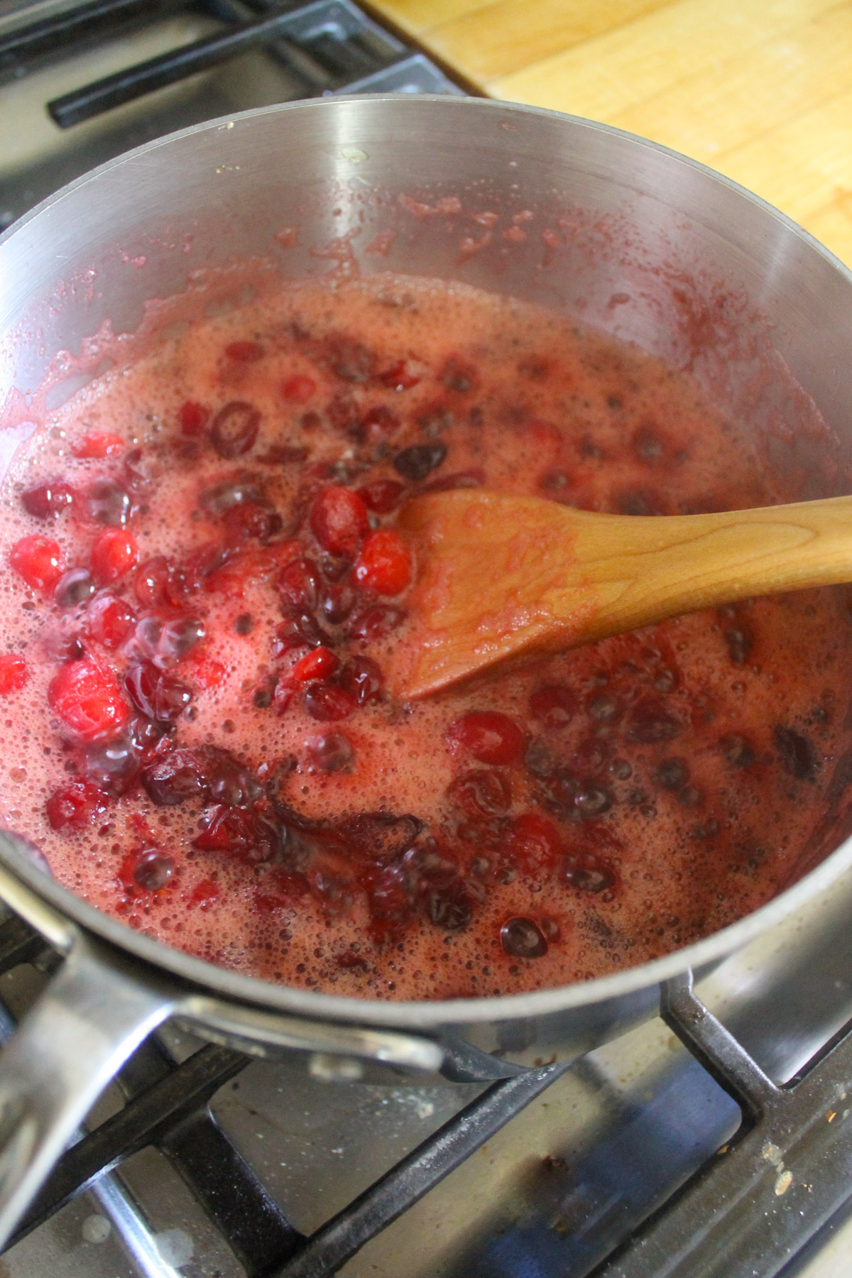 Cranberry sauce simmering on the stove.