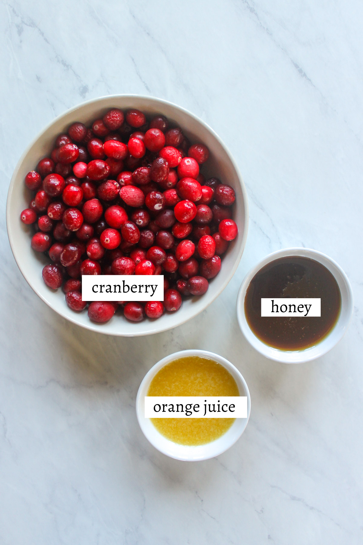 Labeled ingredients for cranberry sauce with honey.