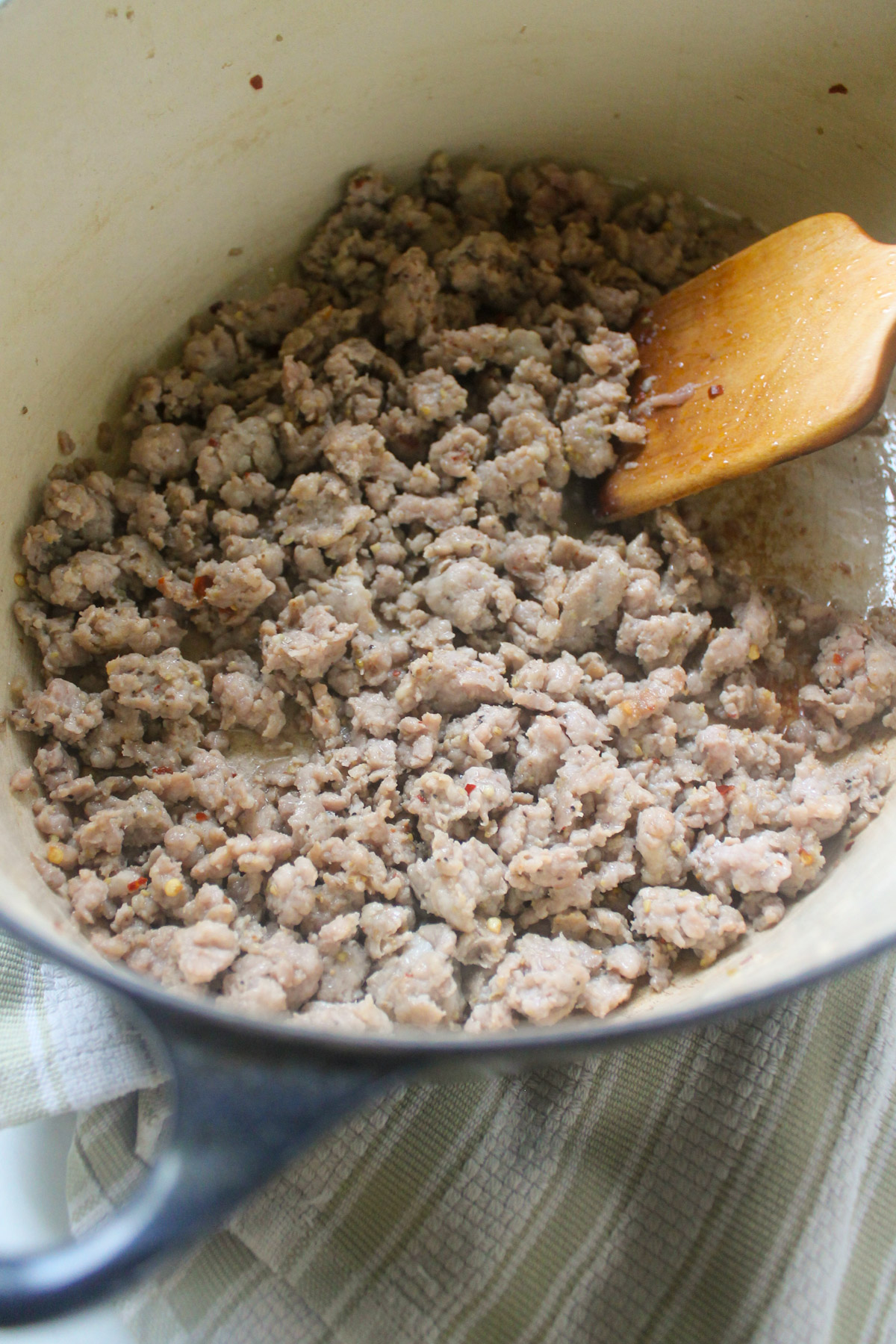 Ground Italian sausage cooking in a pot.