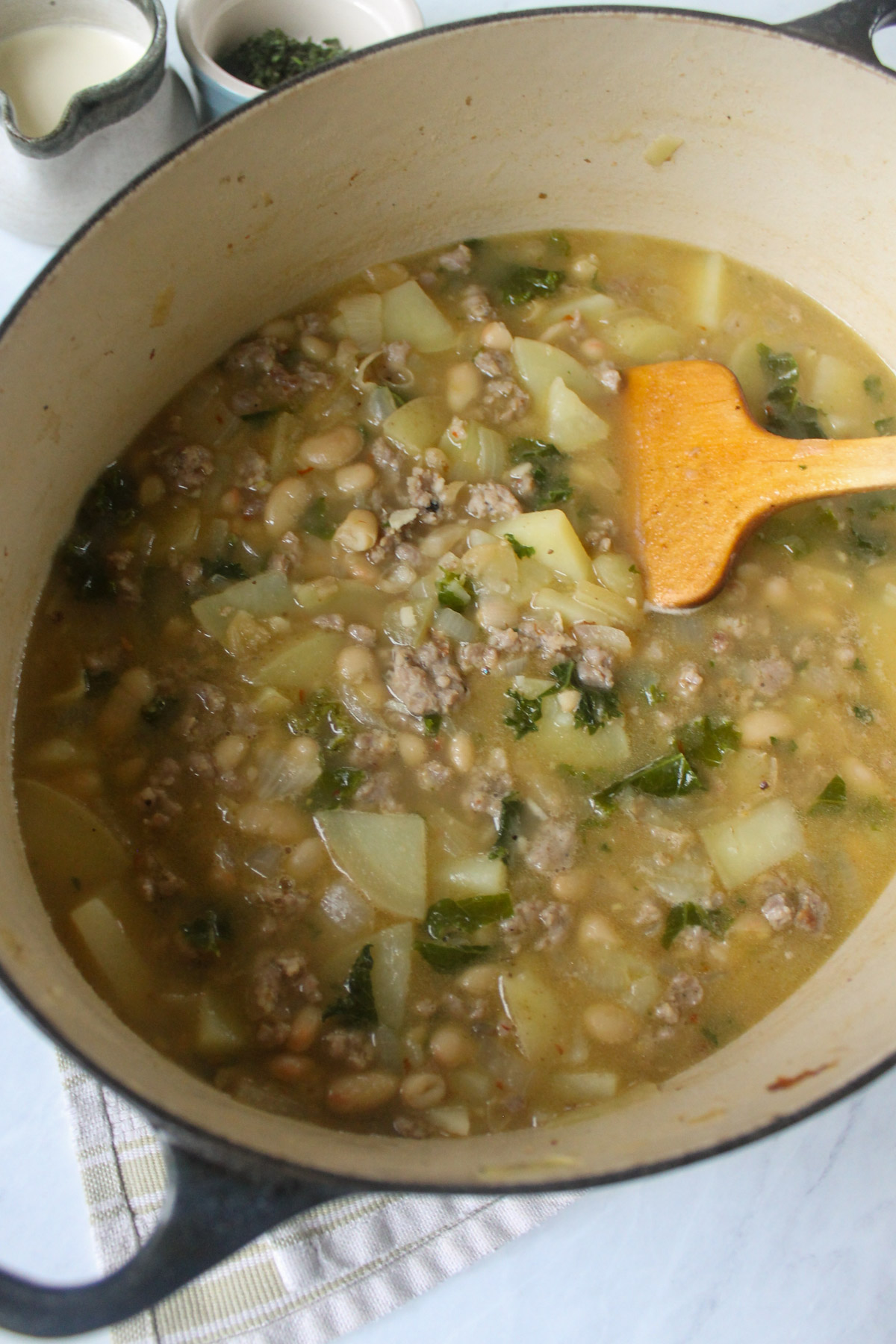 Broth soup with sausage, potatoes, white beans and kale.