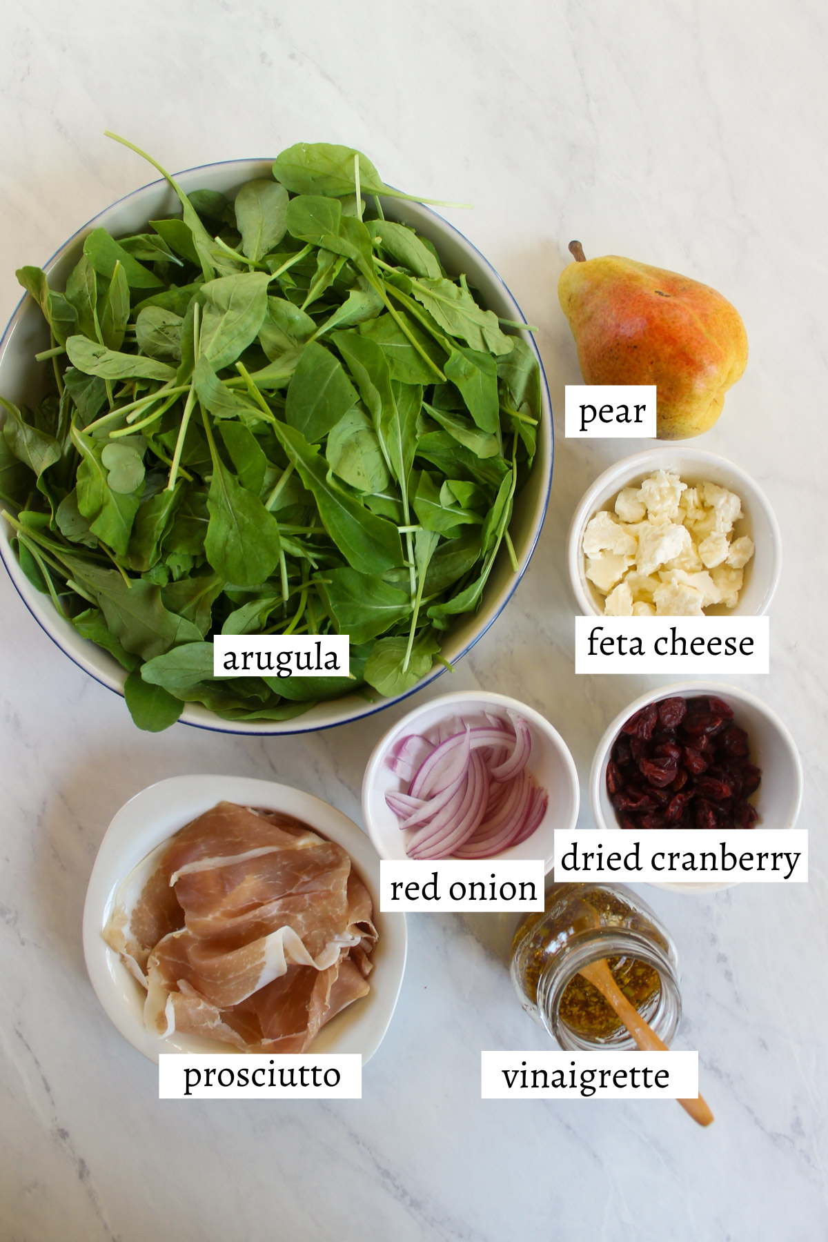 Labeled ingredients for pear arugula salad.