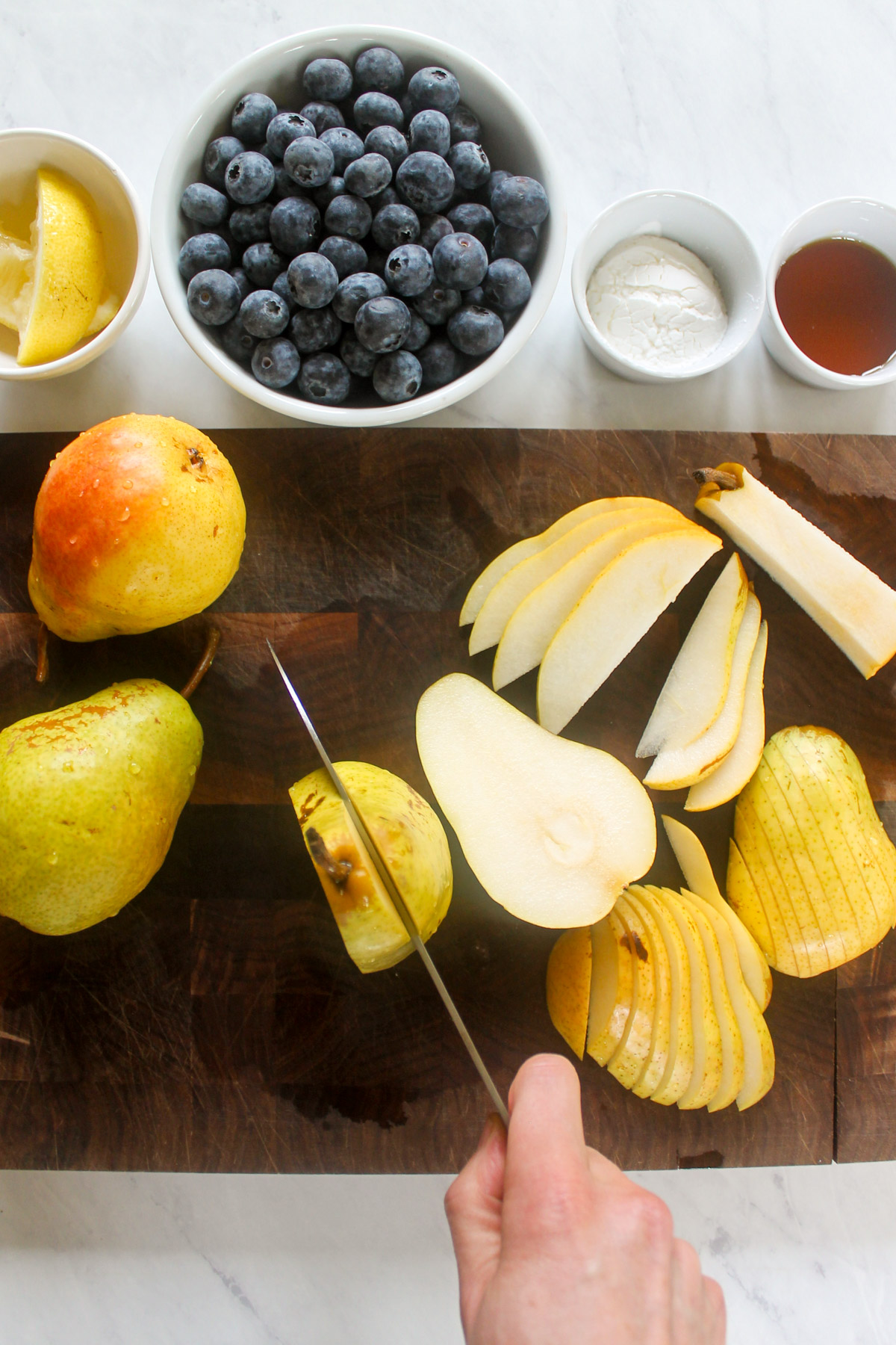 Slicing pears on a cutting board.