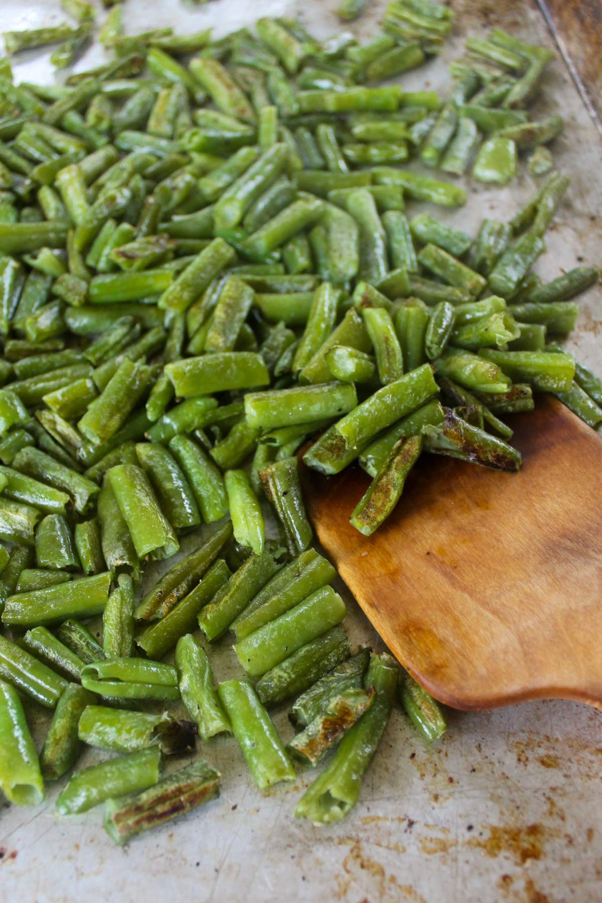 Roasted frozen green beans on a pan.