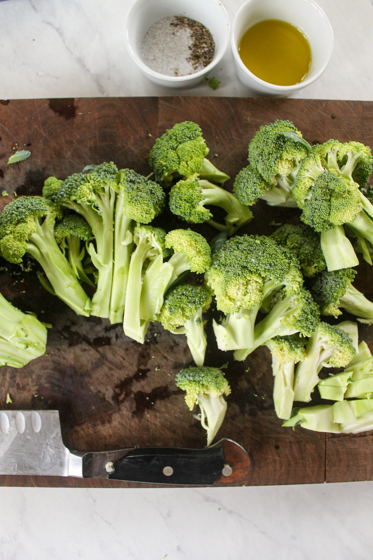 Chopped broccoli florets on a cutting board.