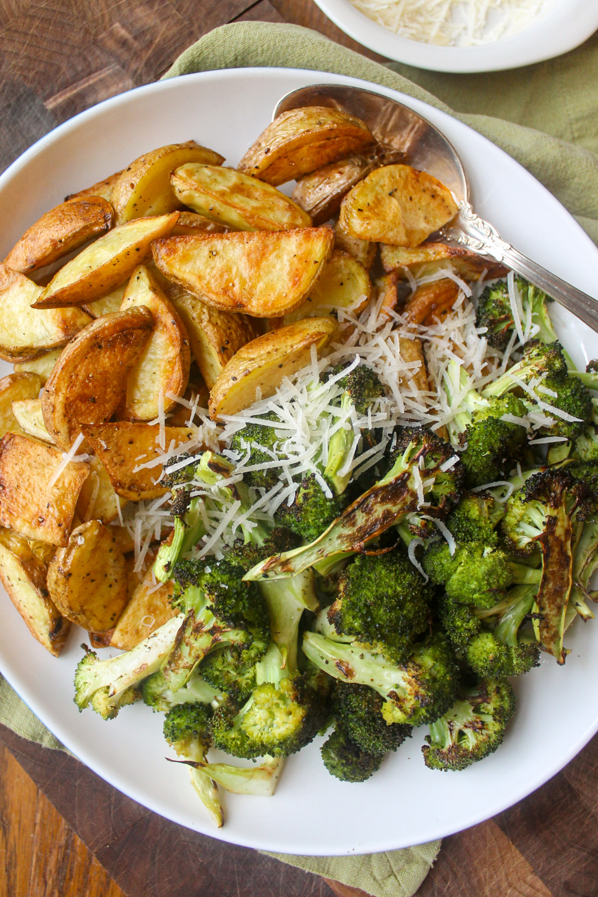 A platter of roasted potatoes with broccoli.