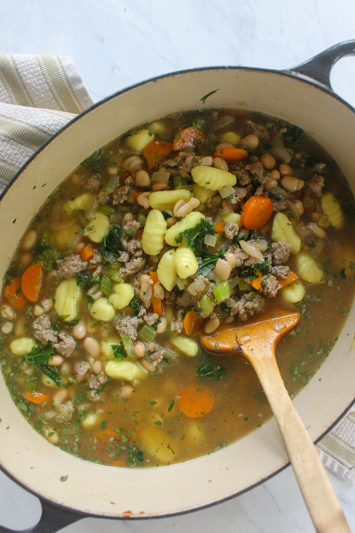 A pot of sausage gnocchi soup ready to simmer.