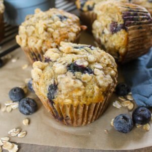 Healthy blueberry banana oatmeal muffins with fresh blueberries.