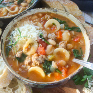 A bowl of white bean pasta sausage soup.