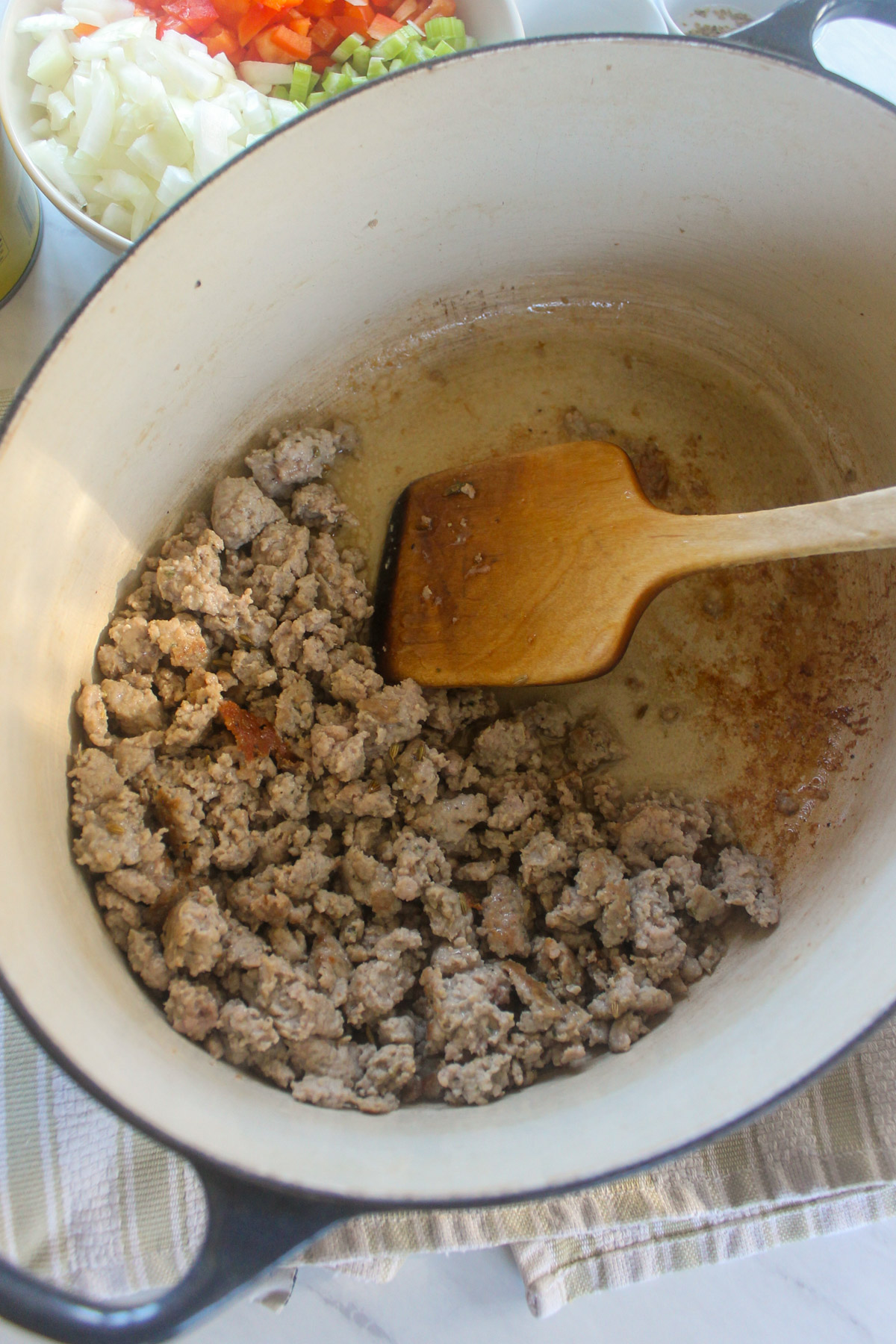 Bulk ground Italian sausage in a soup pot.