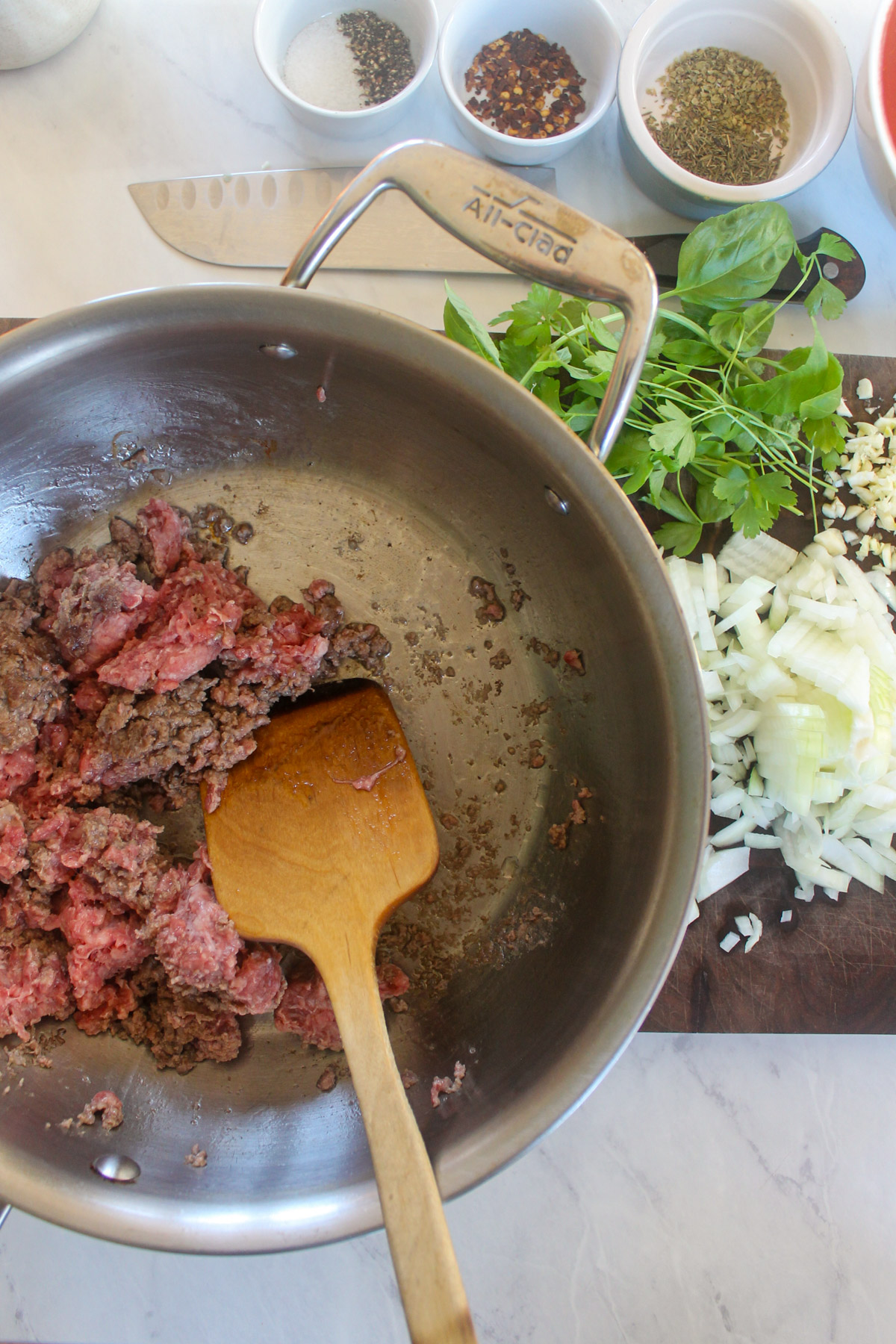 Ground beef cooking in a skillet.