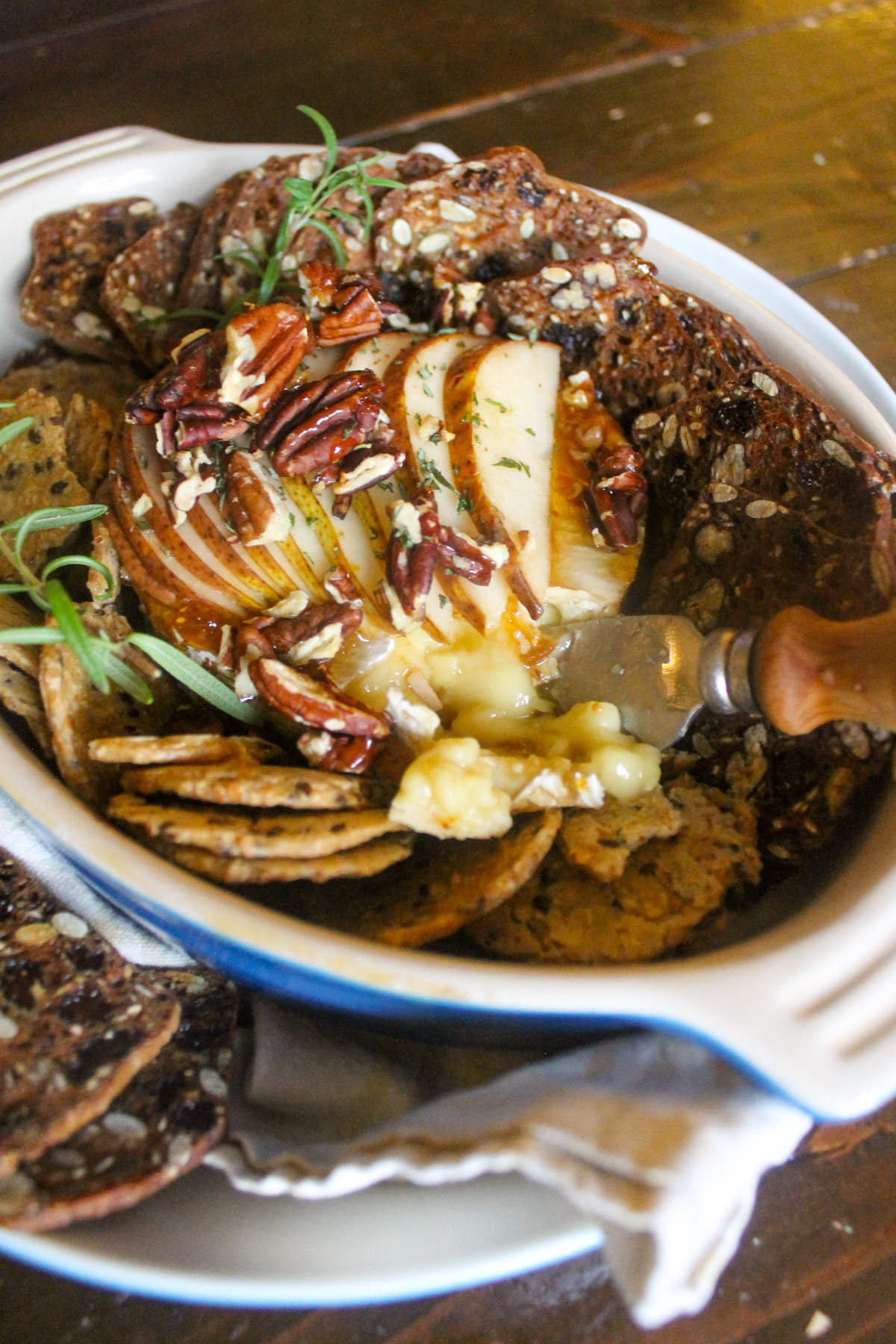 Bakes pears on top of brie with crackers to dip.