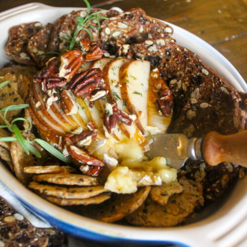 Baked brie with fig jam and sliced pears and nuts.