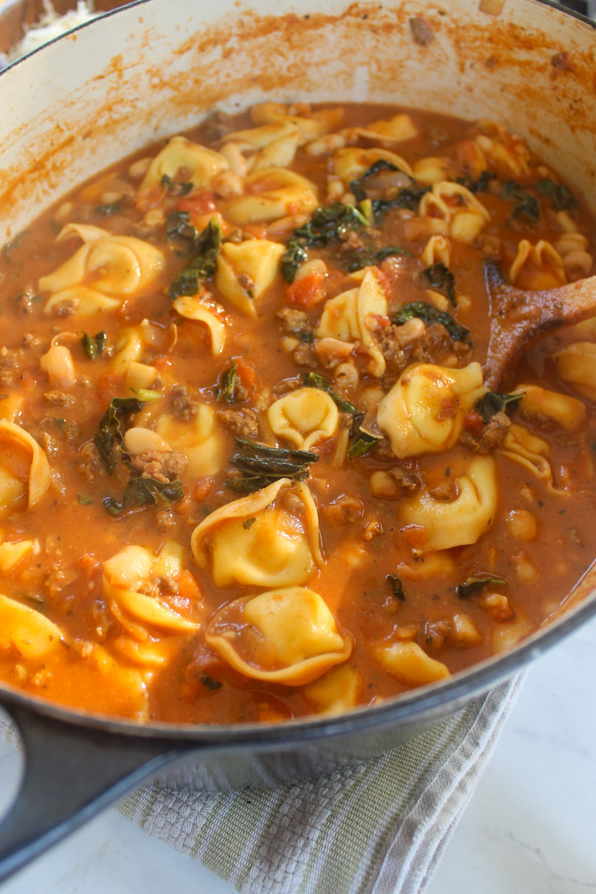 A soup pot of tomato beef tortellini soup.