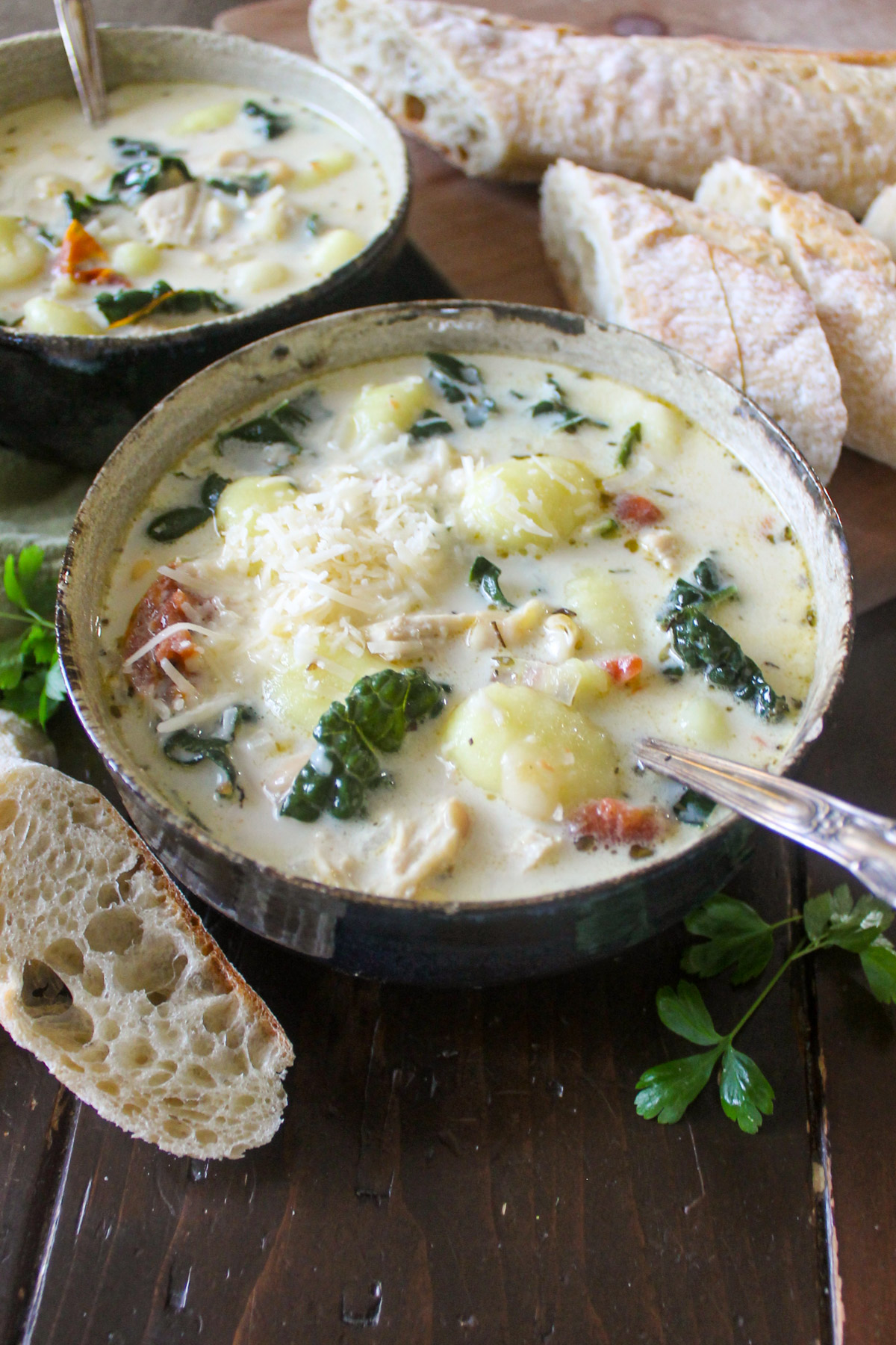 A bowl of chicken kale gnocchi soup in a creamy broth.