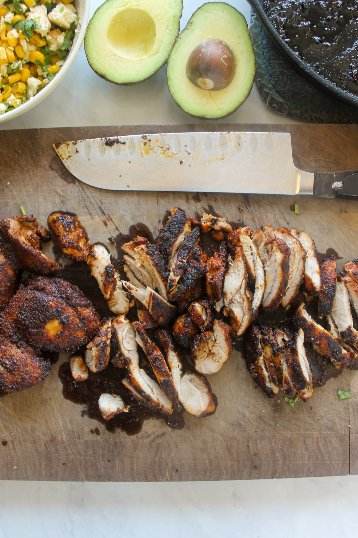 Blackened chicken sliced on a cutting board.