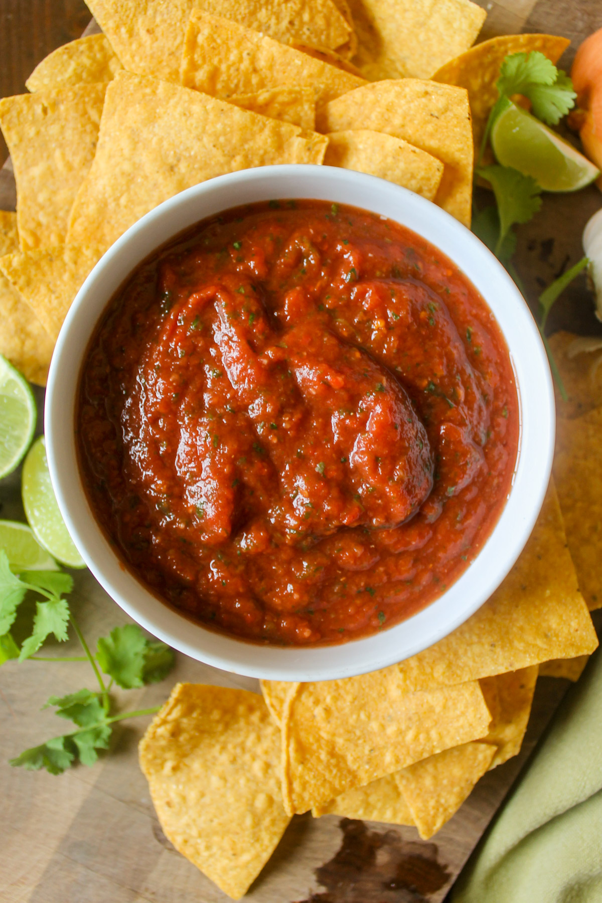 A bowl of chipotle blender salsa with lime wedges.