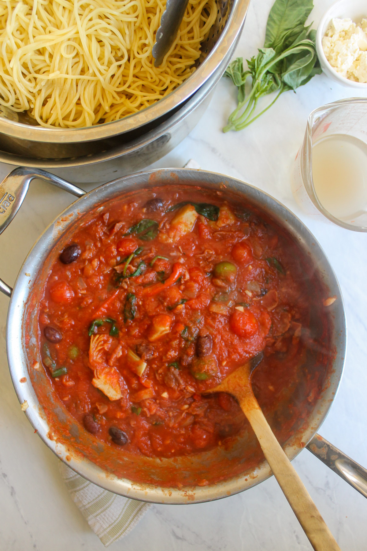 Tomato sauce with olives, peppers and artichokes.