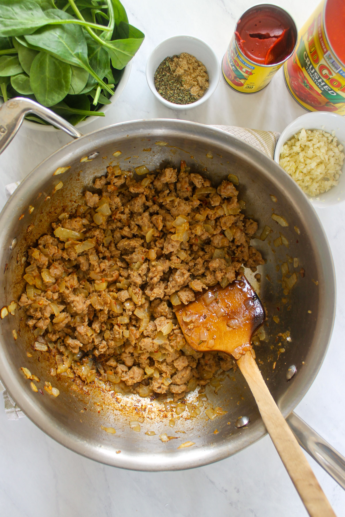 Italian sausage and onions browned in a skillet.