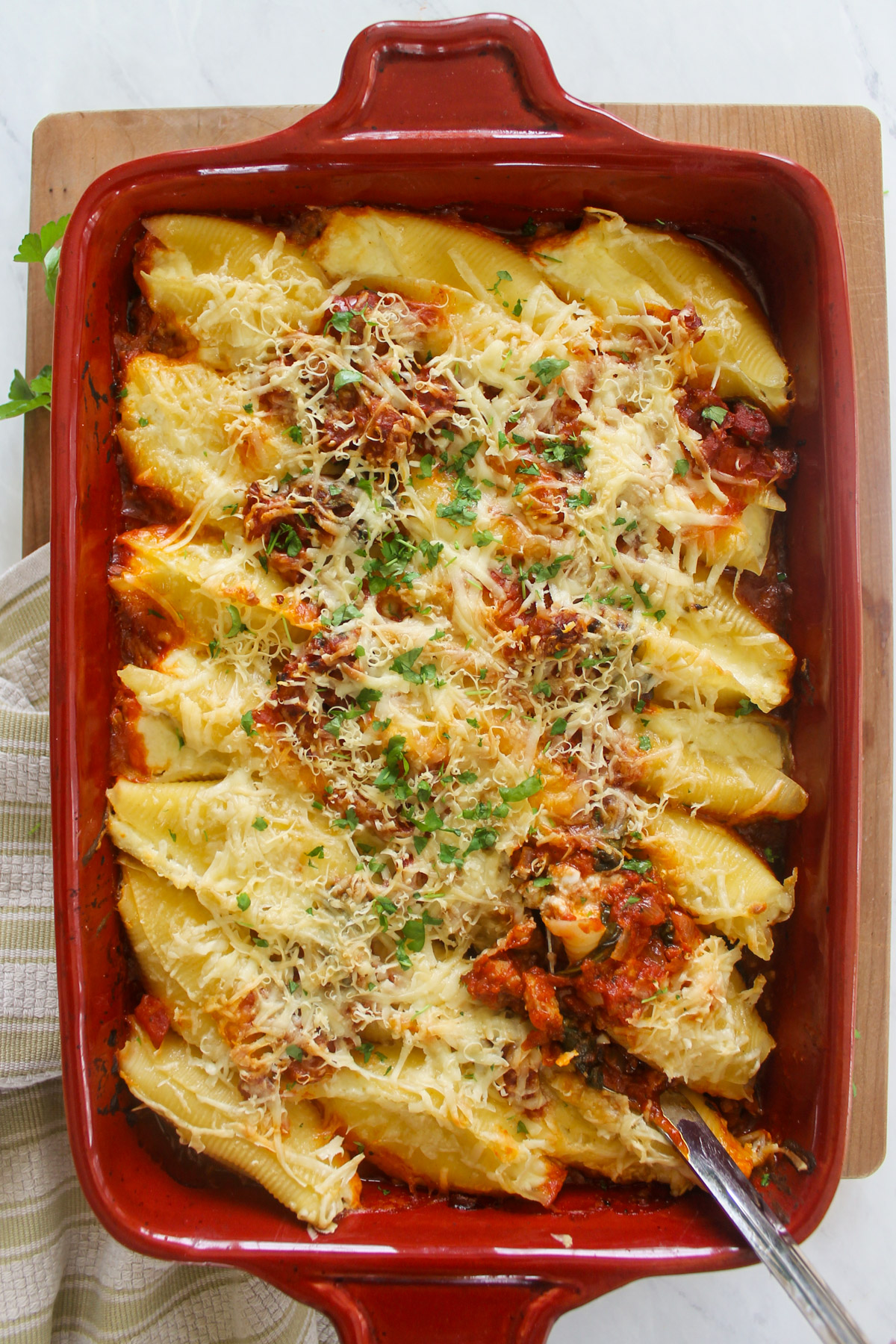 Baked stuffed shells with sausage spinach sauce.