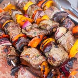 Grilled kabobs with steak, red and yellow bell pepper and mushrooms.